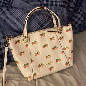 white strawberry coach bag